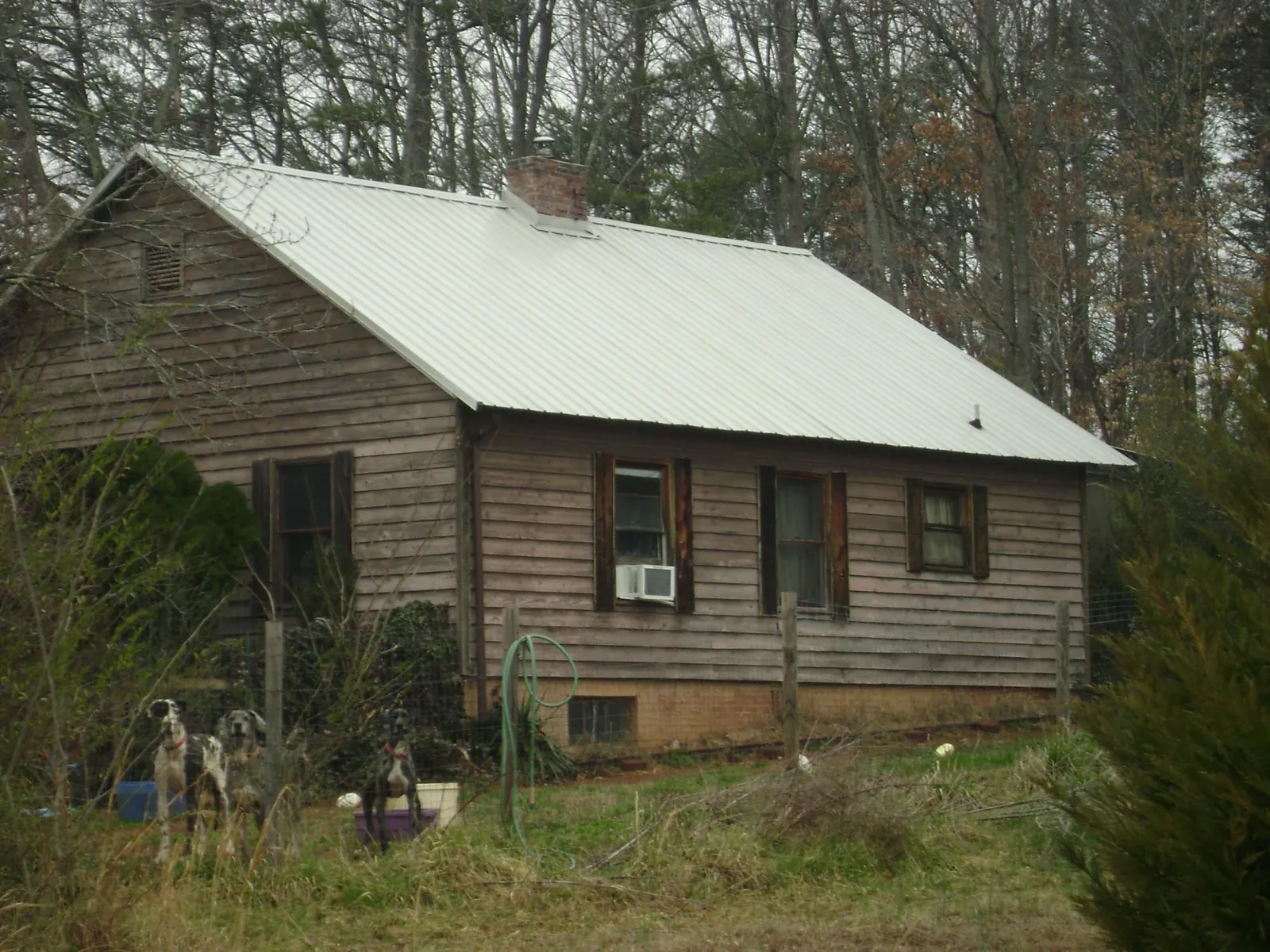 White metal roof on an old wood sided farmhouse, from a Asphalt Shingle Roof Repair job in Strongsville